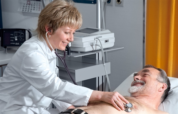 Doctor examining patient with stethoscope