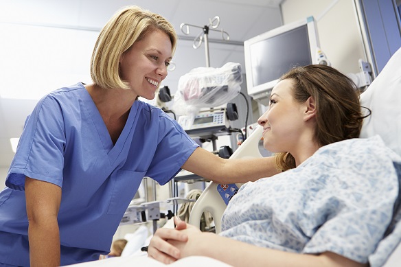 Young Female Patient Talking To Nurse In Emergency Room